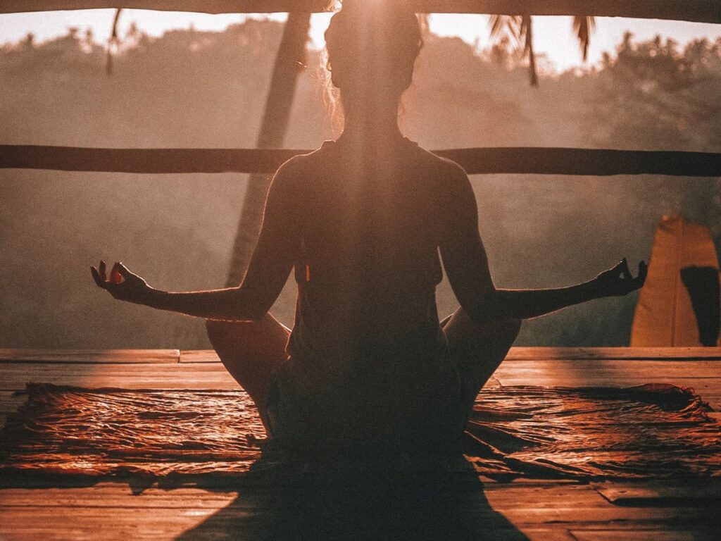 Woman relaxing in sun doing yoga for Naturopathy