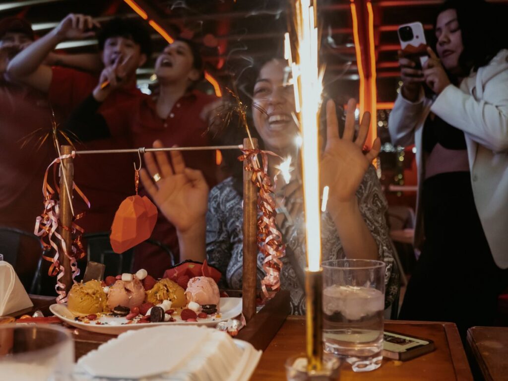 friends and family celebrating birthday in popular restaurant in Toronto. 
