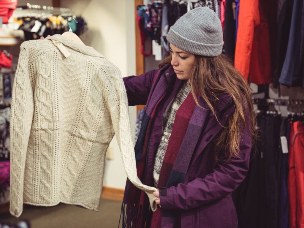 Girl looking at streetwear sweater in a shop in Toronto 