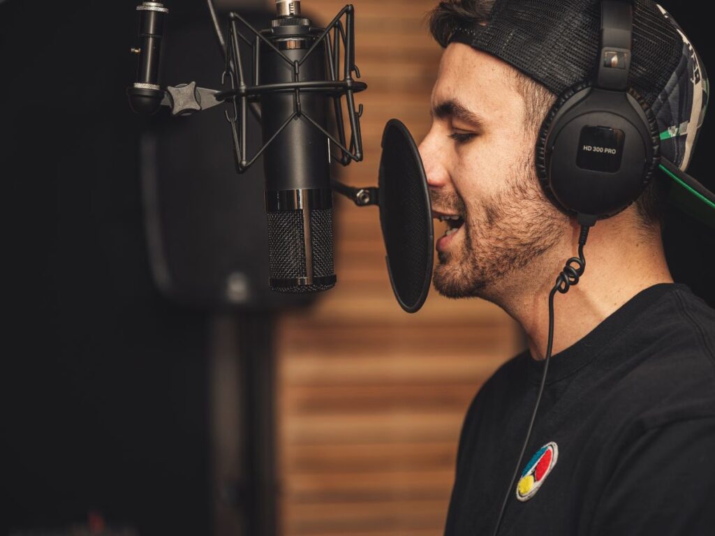 man recording his song in studio