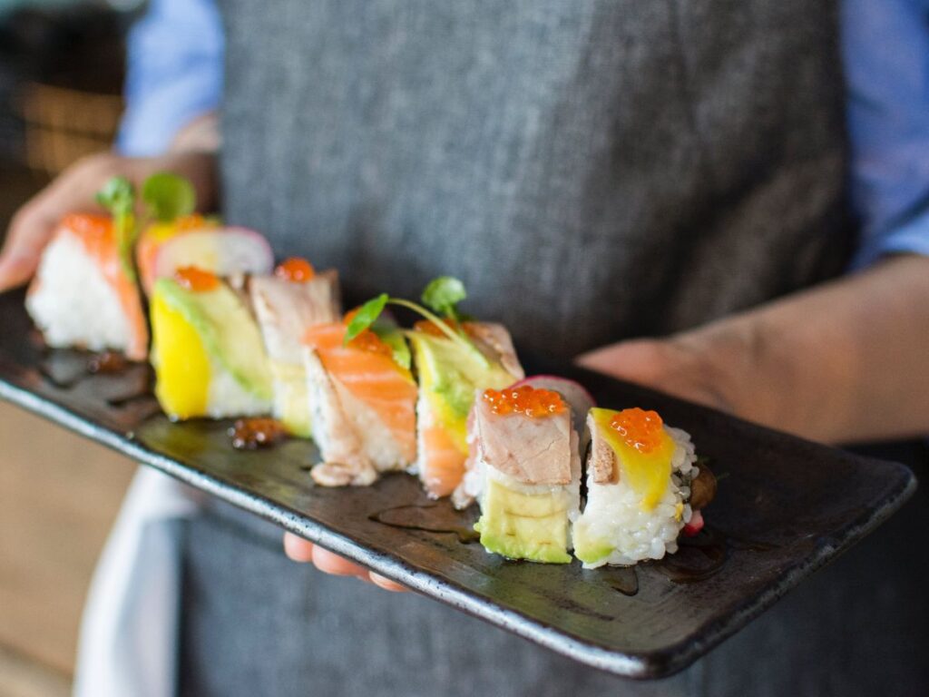 waiter holding sushi