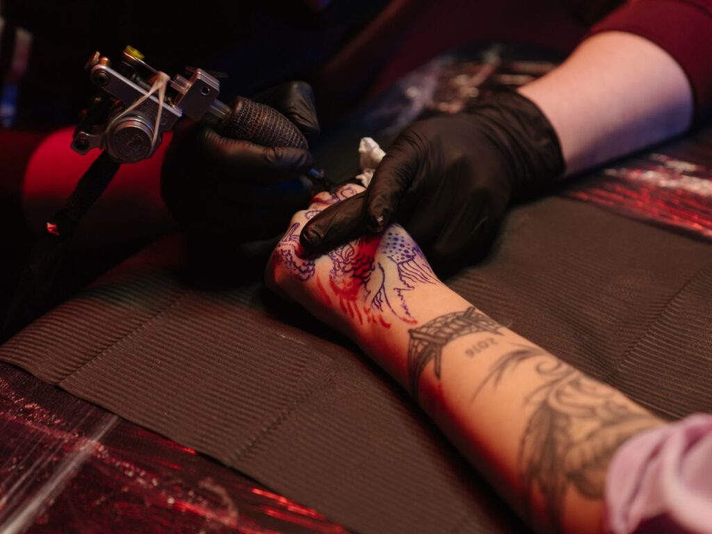 hand getting tattooed