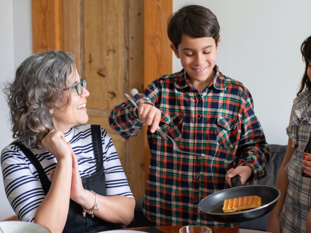 kid making a waffle at home