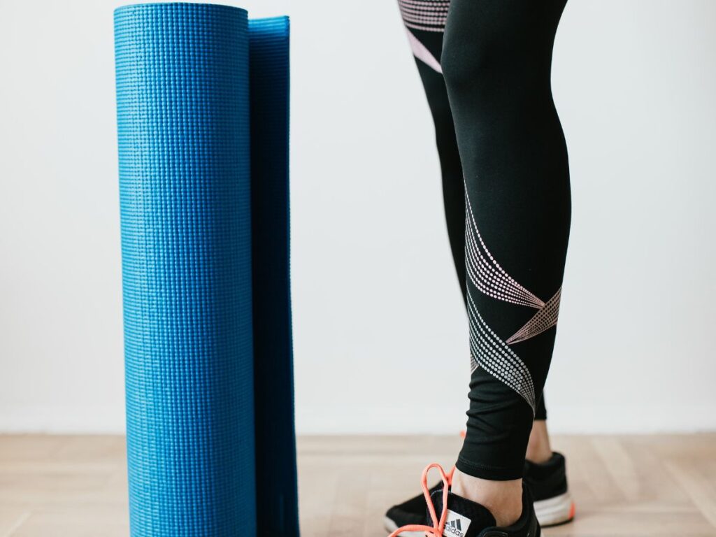 woman holding yoga mat