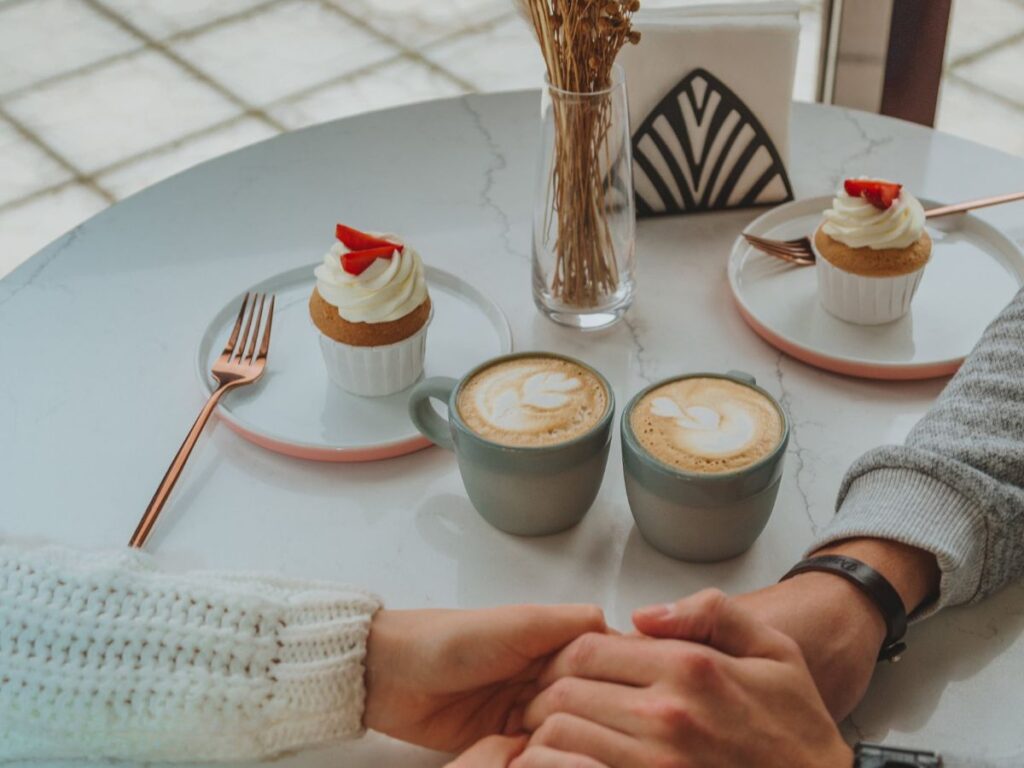 holding hands in cafe