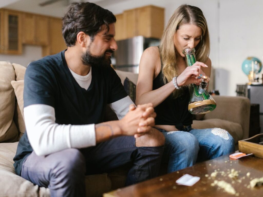 man and woman smoking cannabis