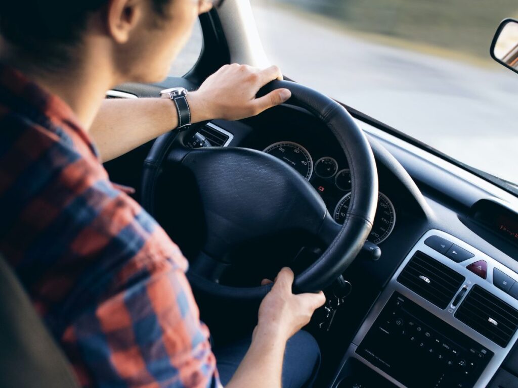 man driving car