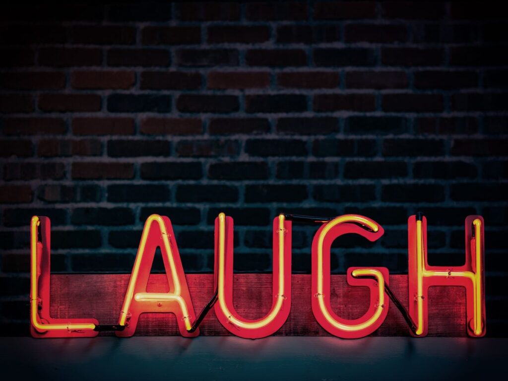 laugh in neon sign