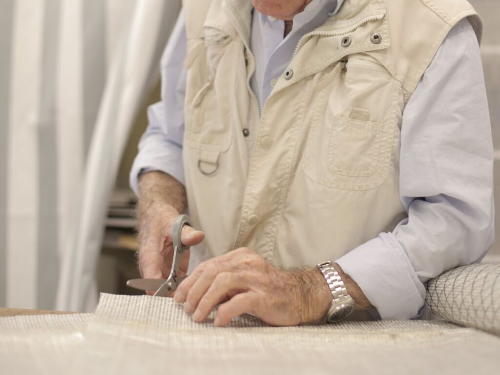 man cutting fabric