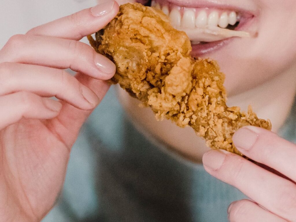 biting fried chicken