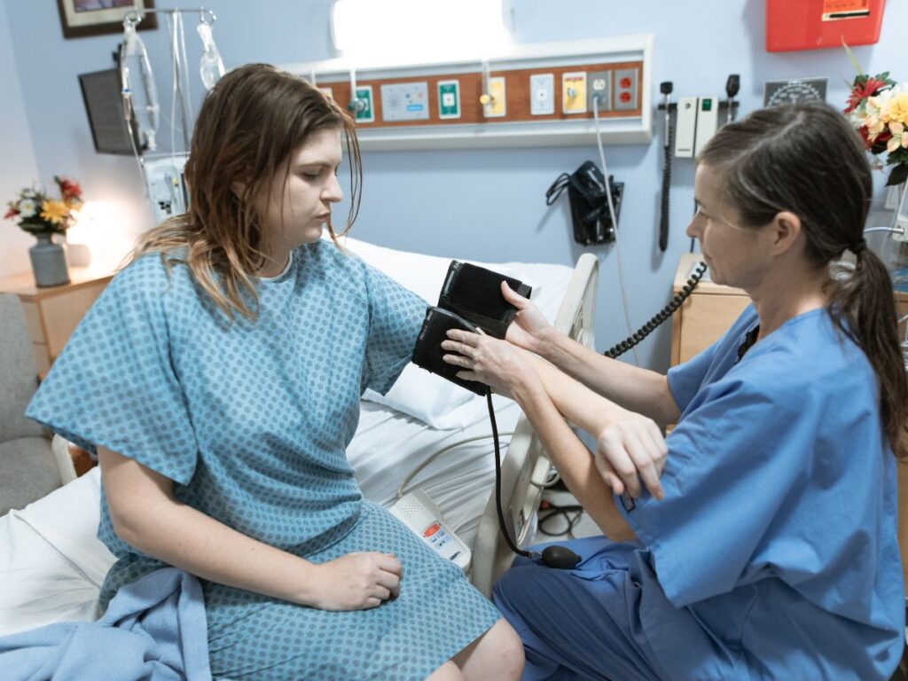 checking blood pressure of patient