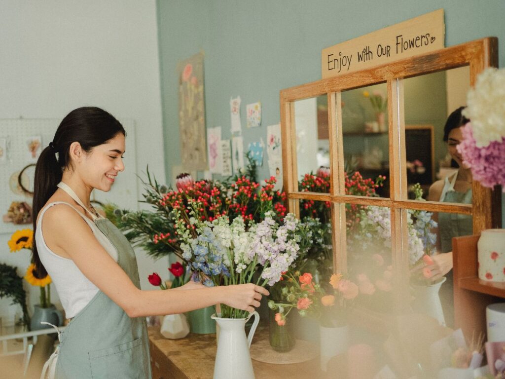 girl putting flowers in a vase