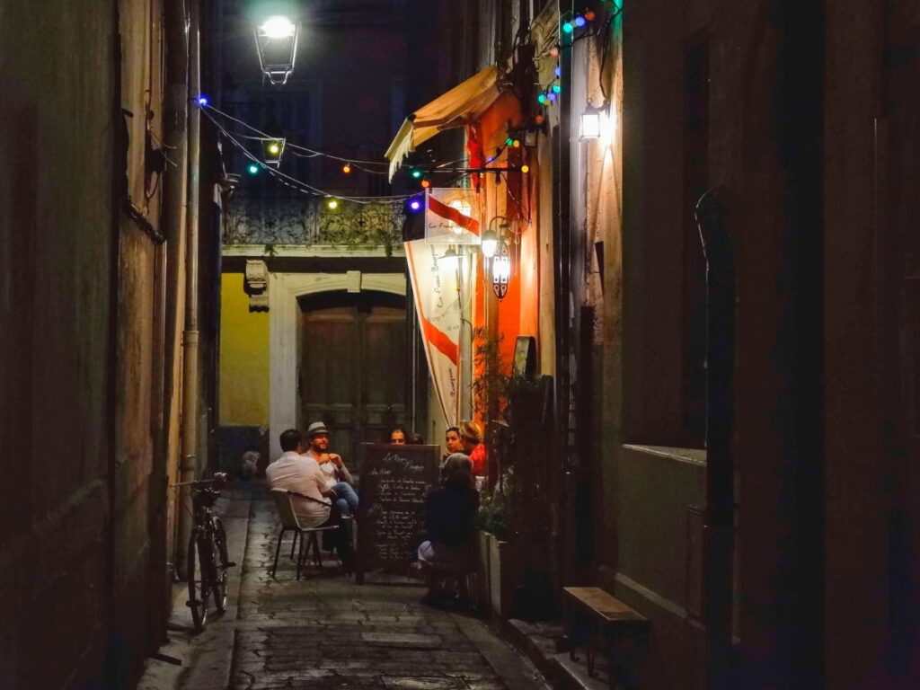 people sitting in an outdoor cafe at night