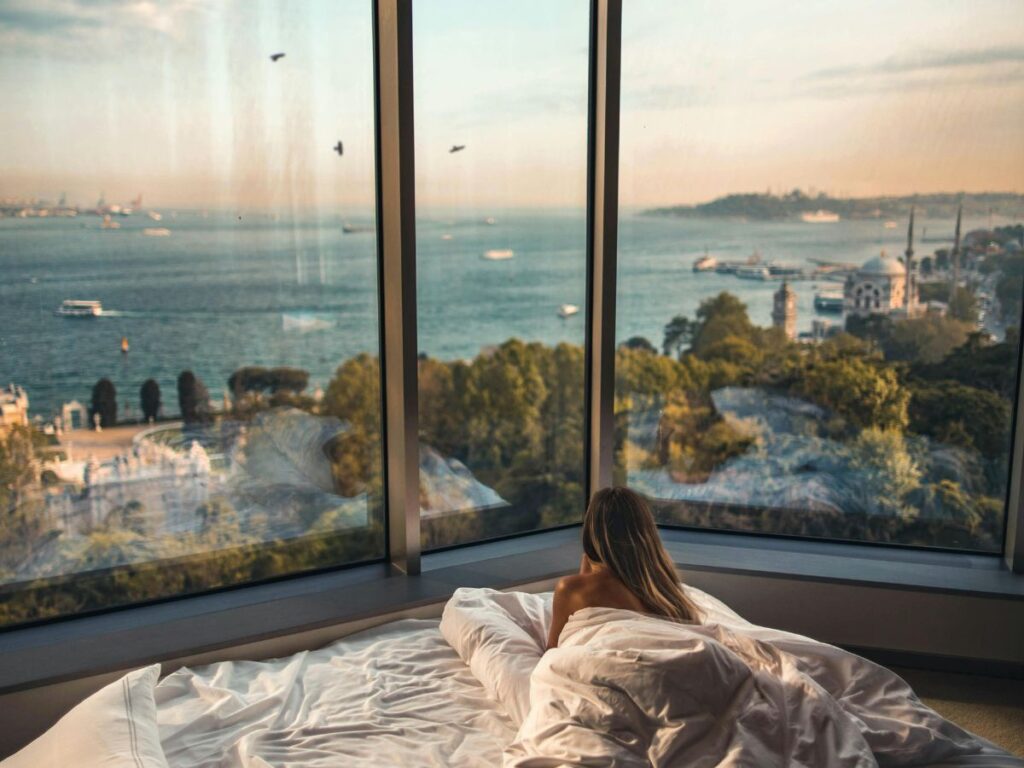 woman looking out her bedroom window