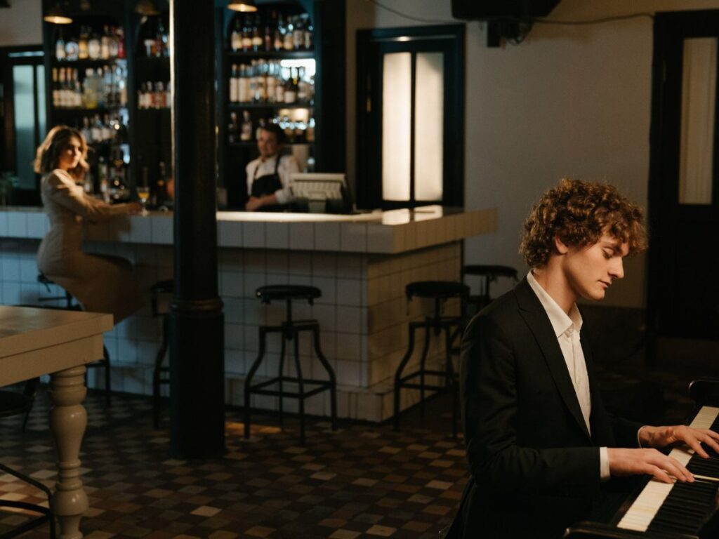 man playing piano in a restaurant