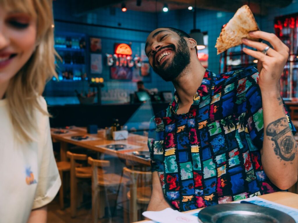 man eating a pizza slice