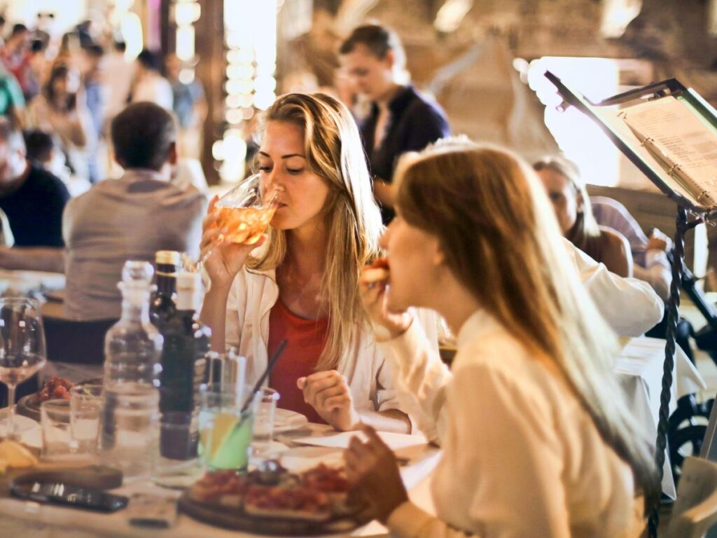 woman drinking wine in restaurant