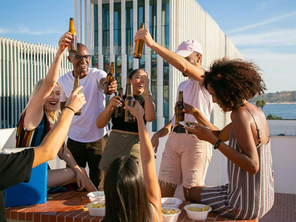 a group enjoying drinks on a rooftop bar