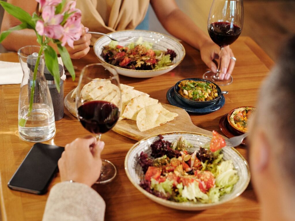 enjoying salad with wine