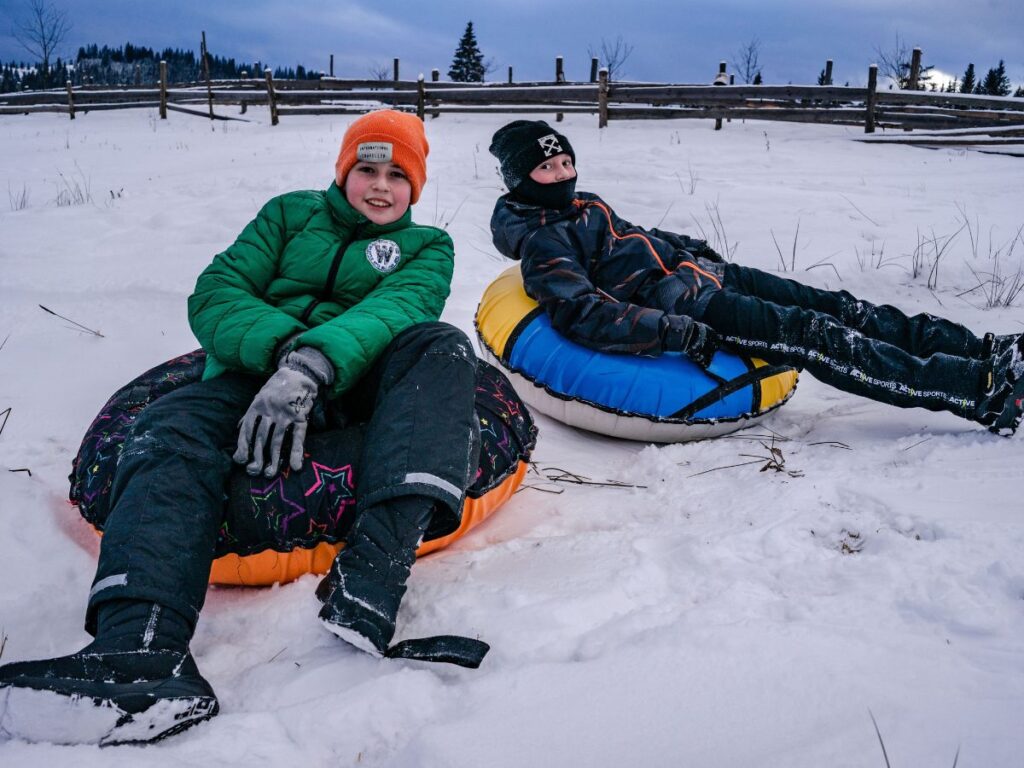 boys on snow tubes