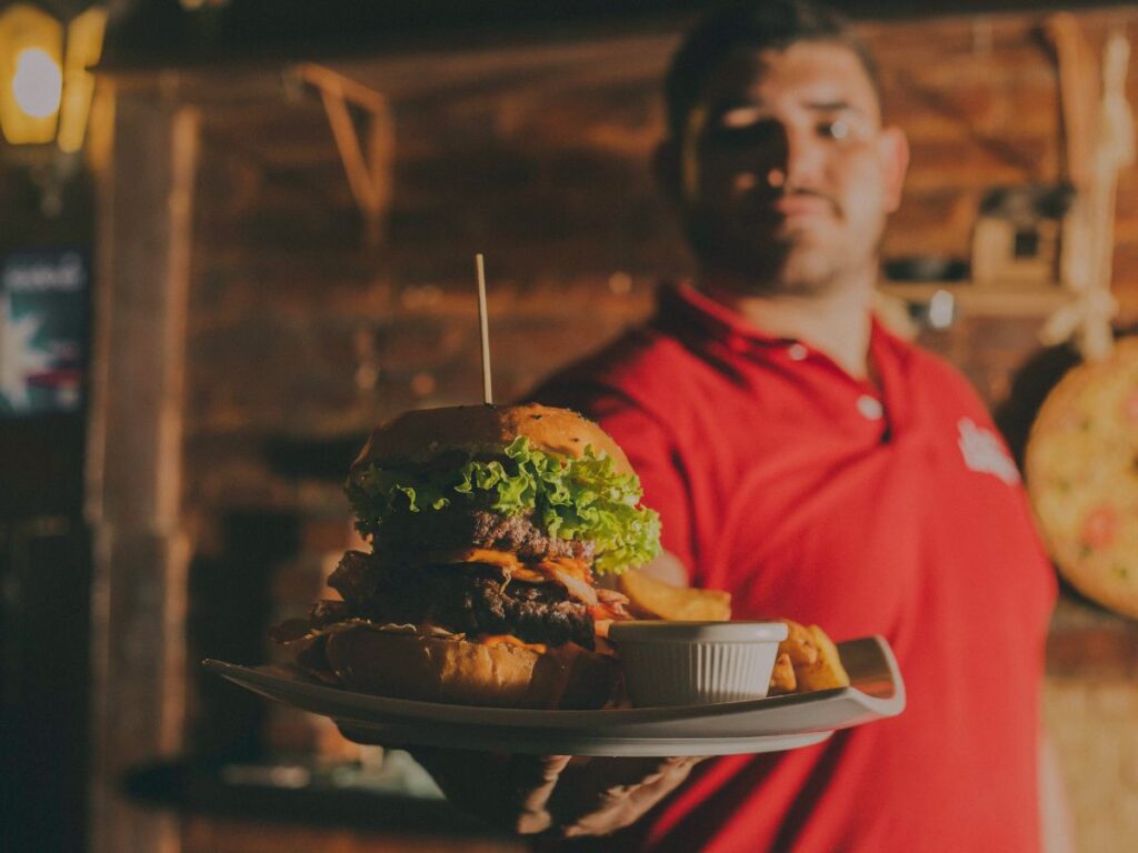 waiter serving burger