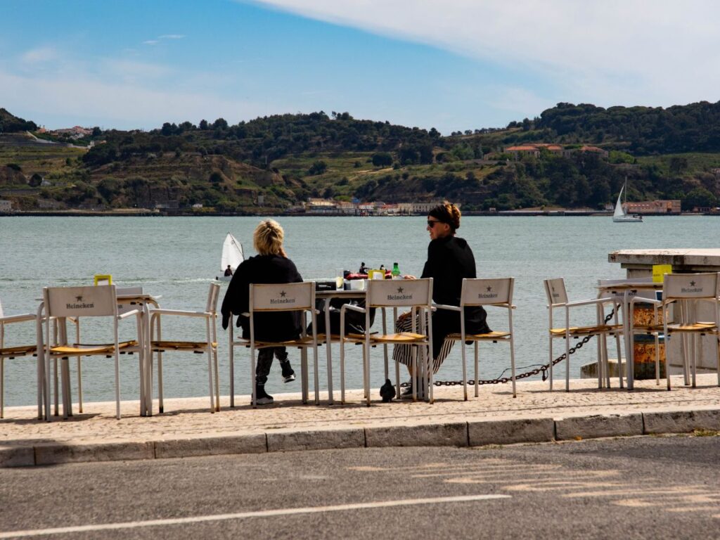 women in open air restaurant with water view