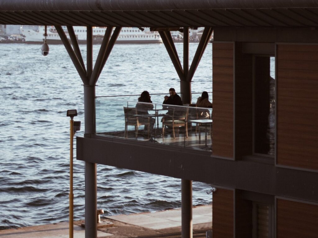people in a restaurant with water view