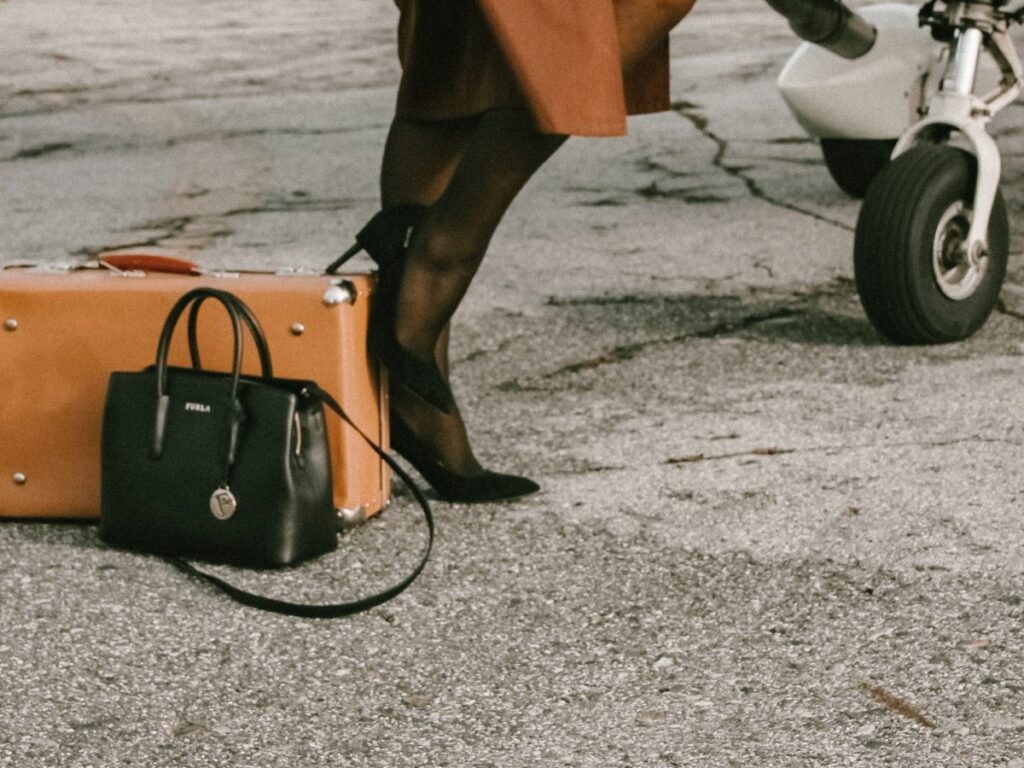 woman's travel bag and hand bag