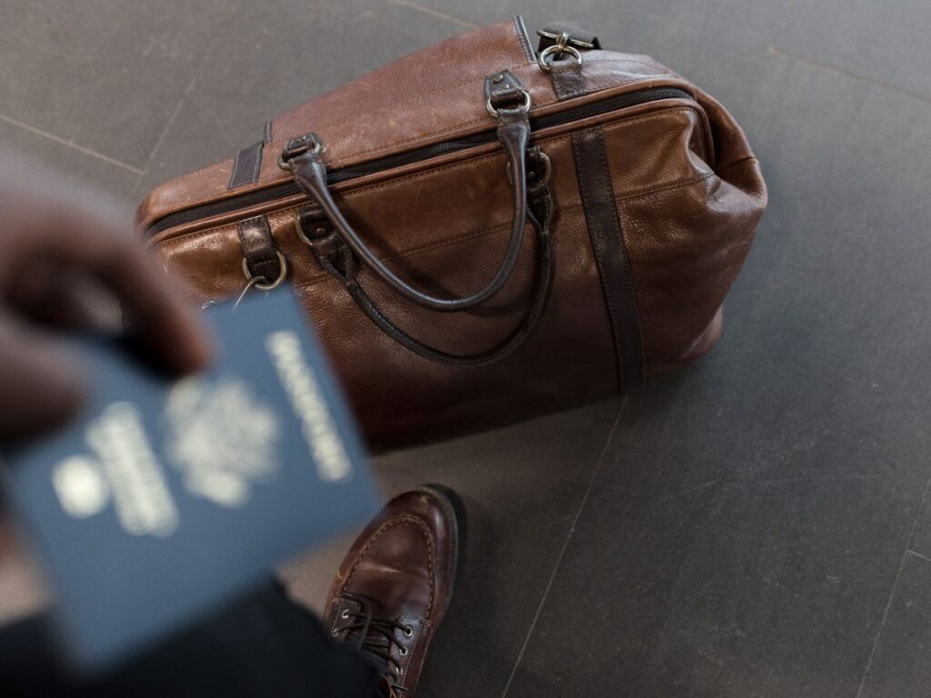 travel bag on floor with passport