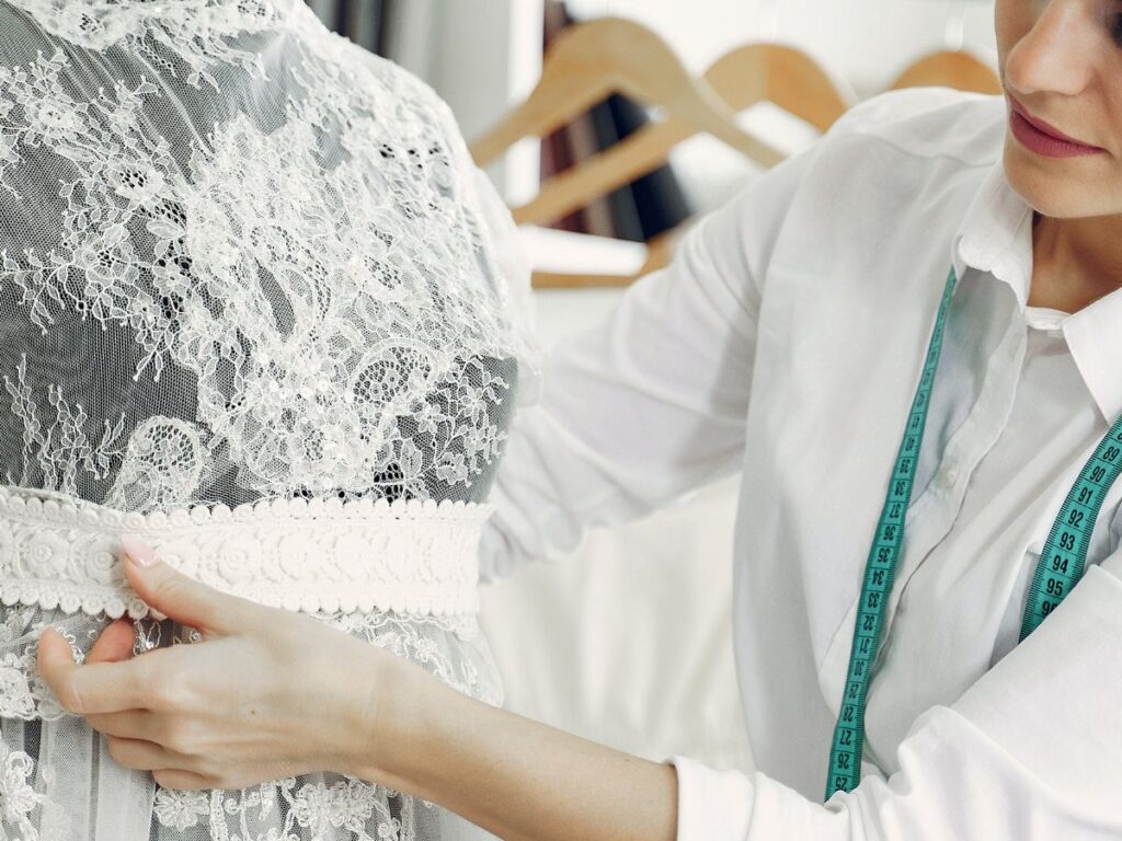 woman stitching a prom dress