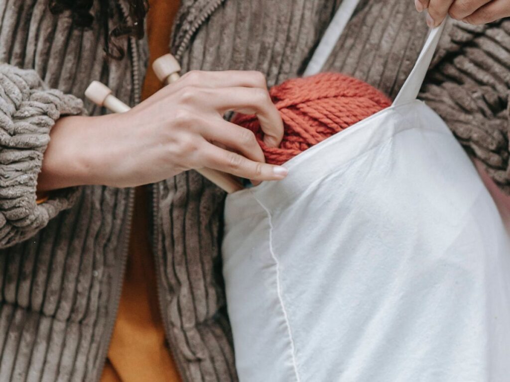 putting wool in a fabric handbag