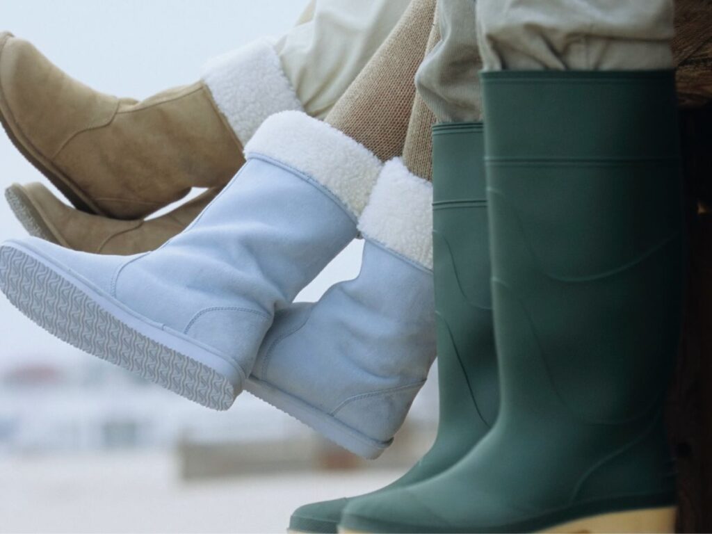 people with boots sitting on cliff