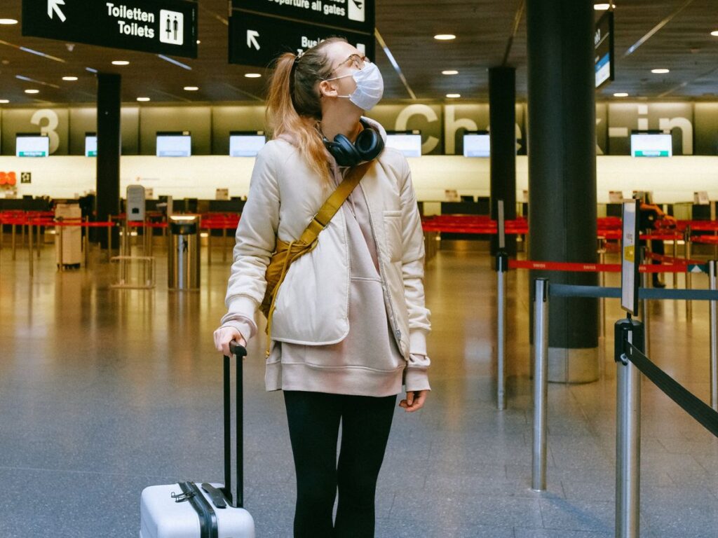 woman holding luggage in airport