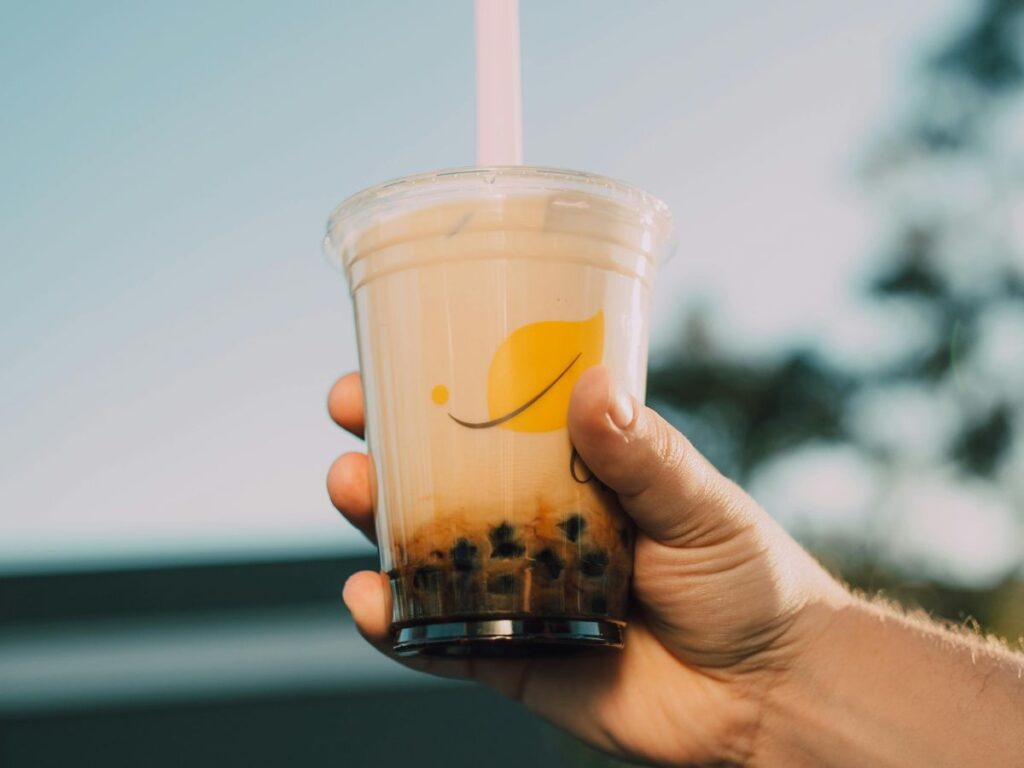 holding a glass of bubble tea