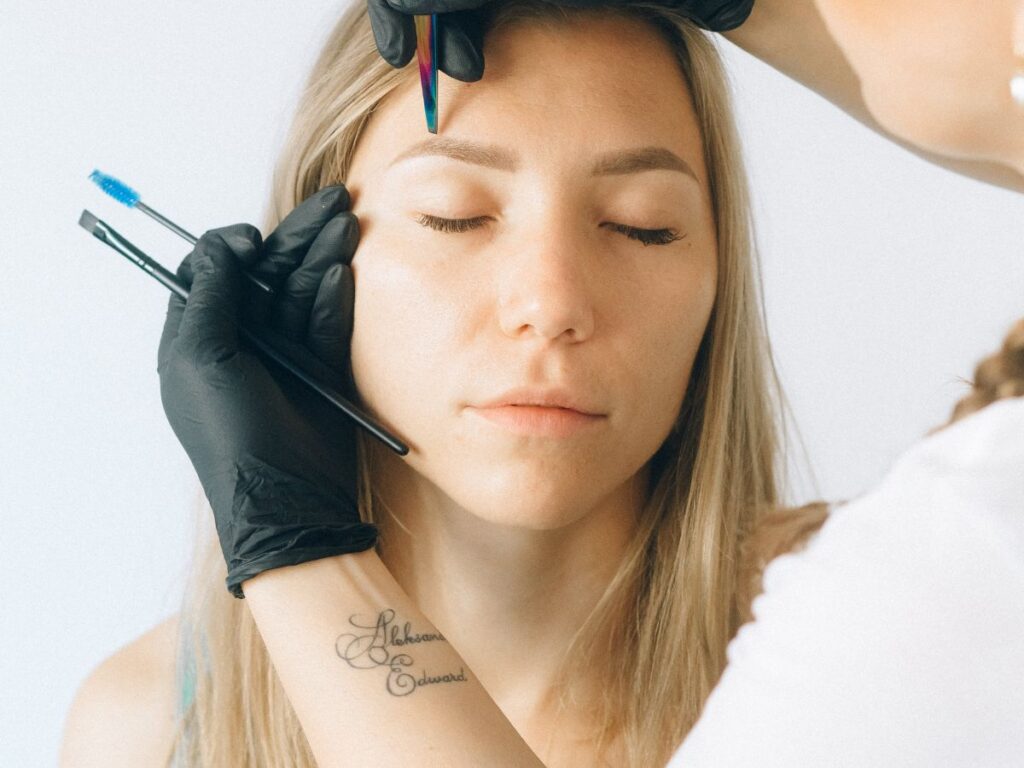 girl getting her eyebrow done