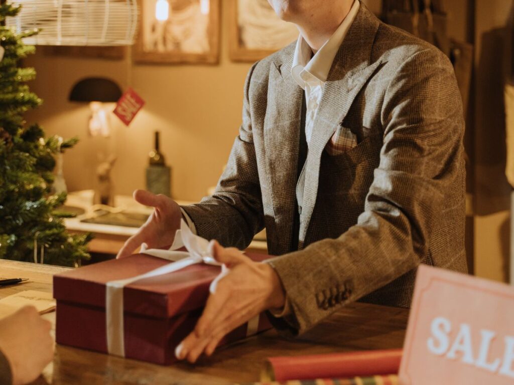 shopkeeper wrapping a gift