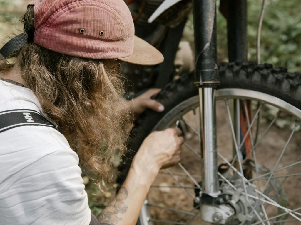 girl checking bike tyre