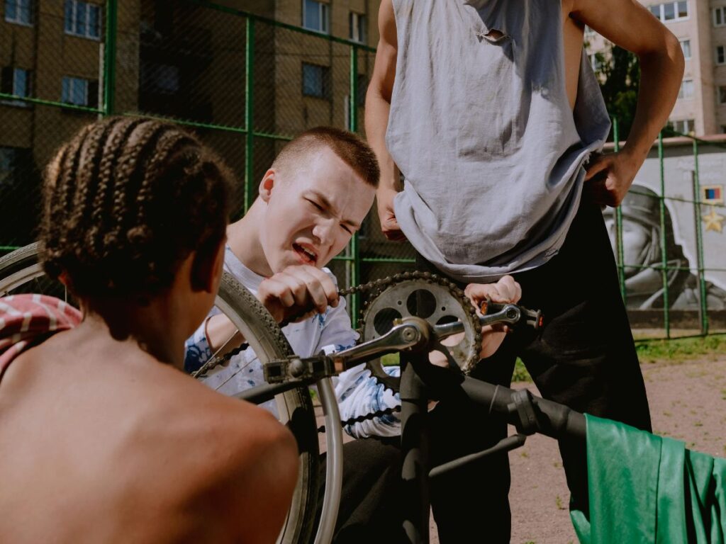 man fixing chain on bike