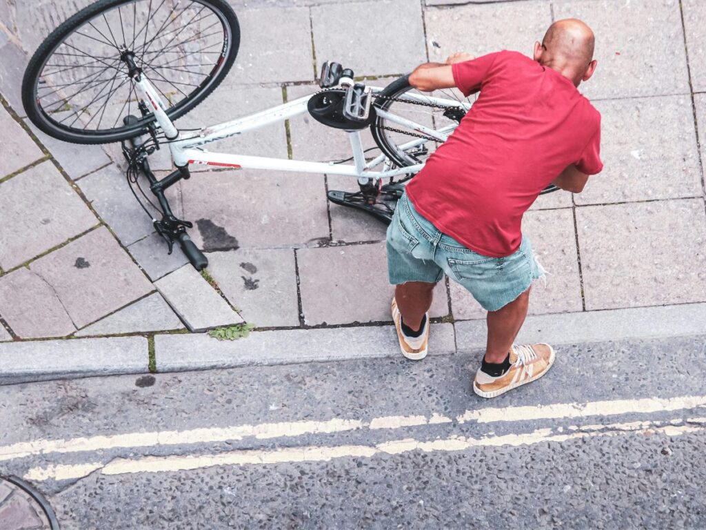 man with his upside down bicycle