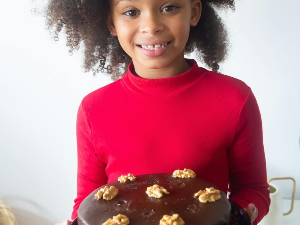 girl holding chocolate cake