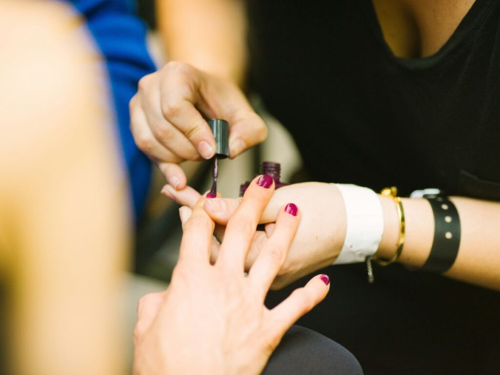 woman getting her nails painted