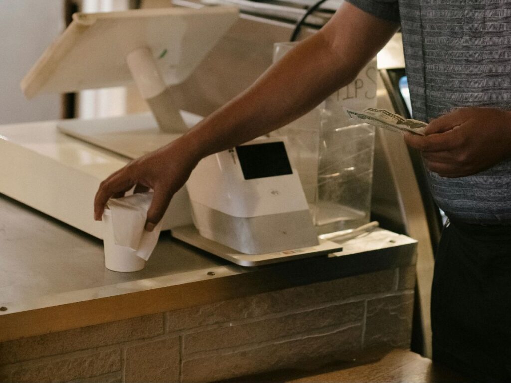 man paying for his cup