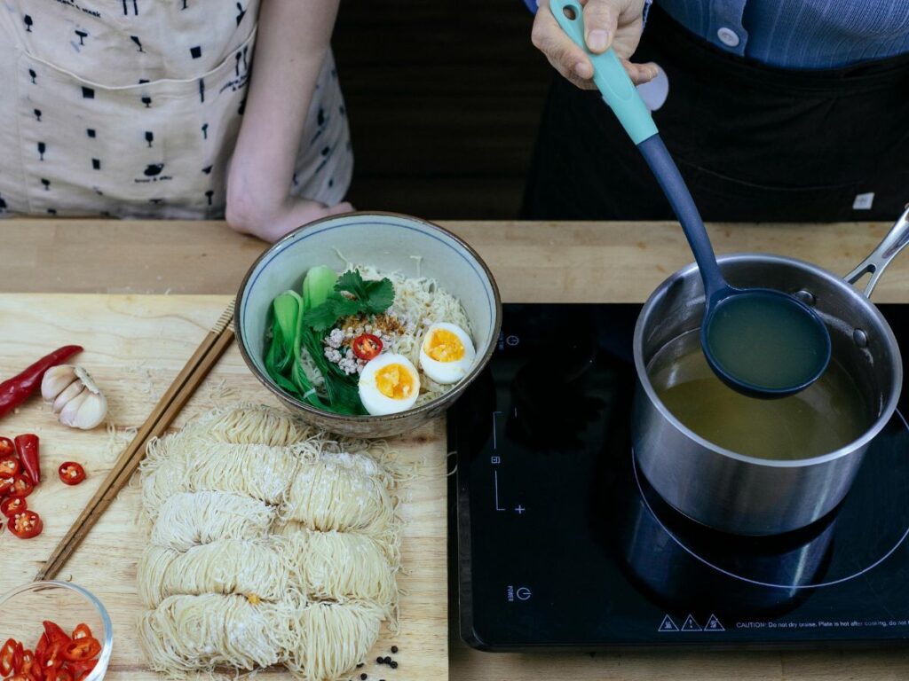 pouring soup in vegetarian ramen