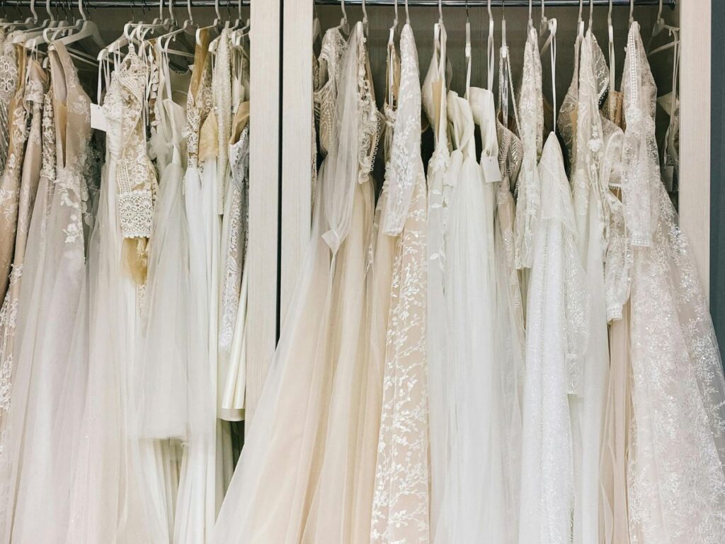 wedding dresses hung in a shop