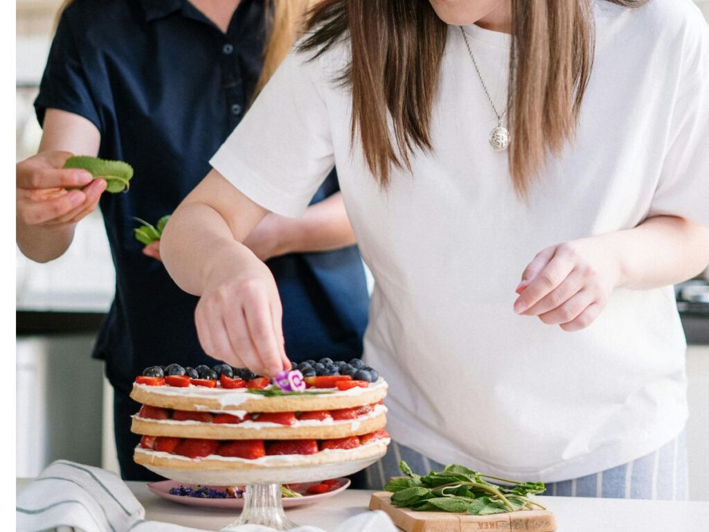 women decorating cake