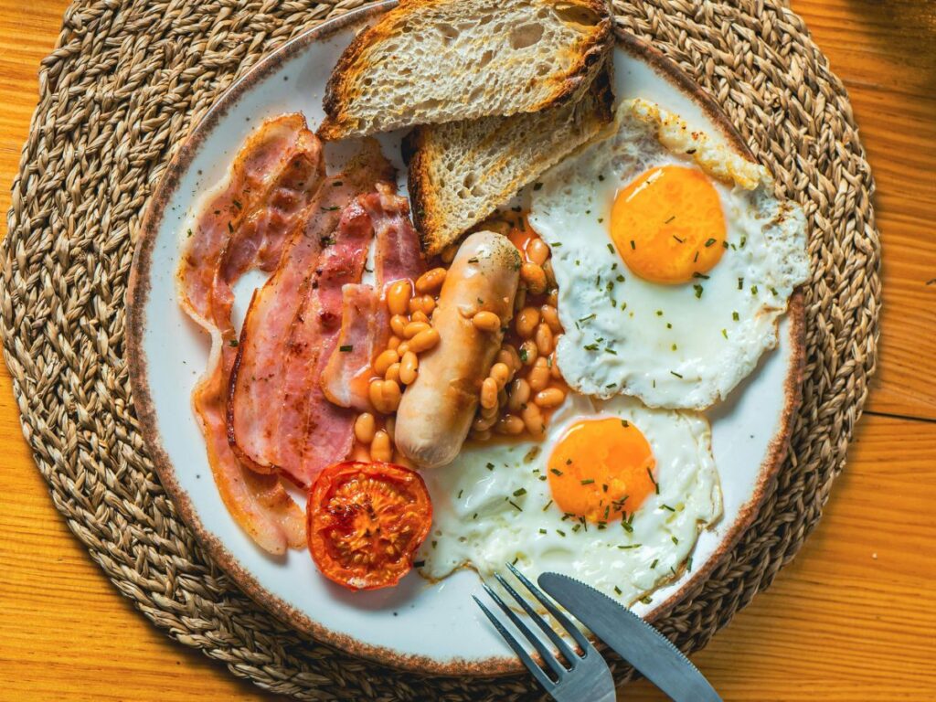 eggs and sausages with vegetables and bread