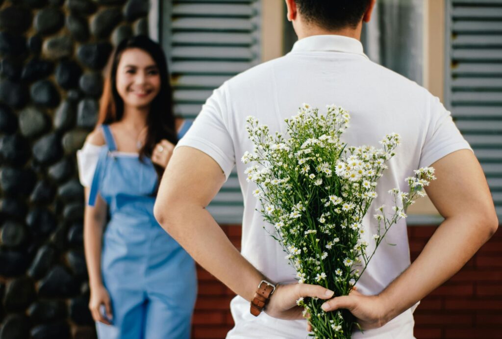 man carrying flowers for his date