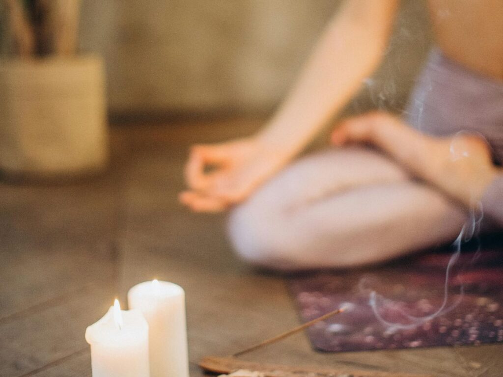 meditating with candles and herbs