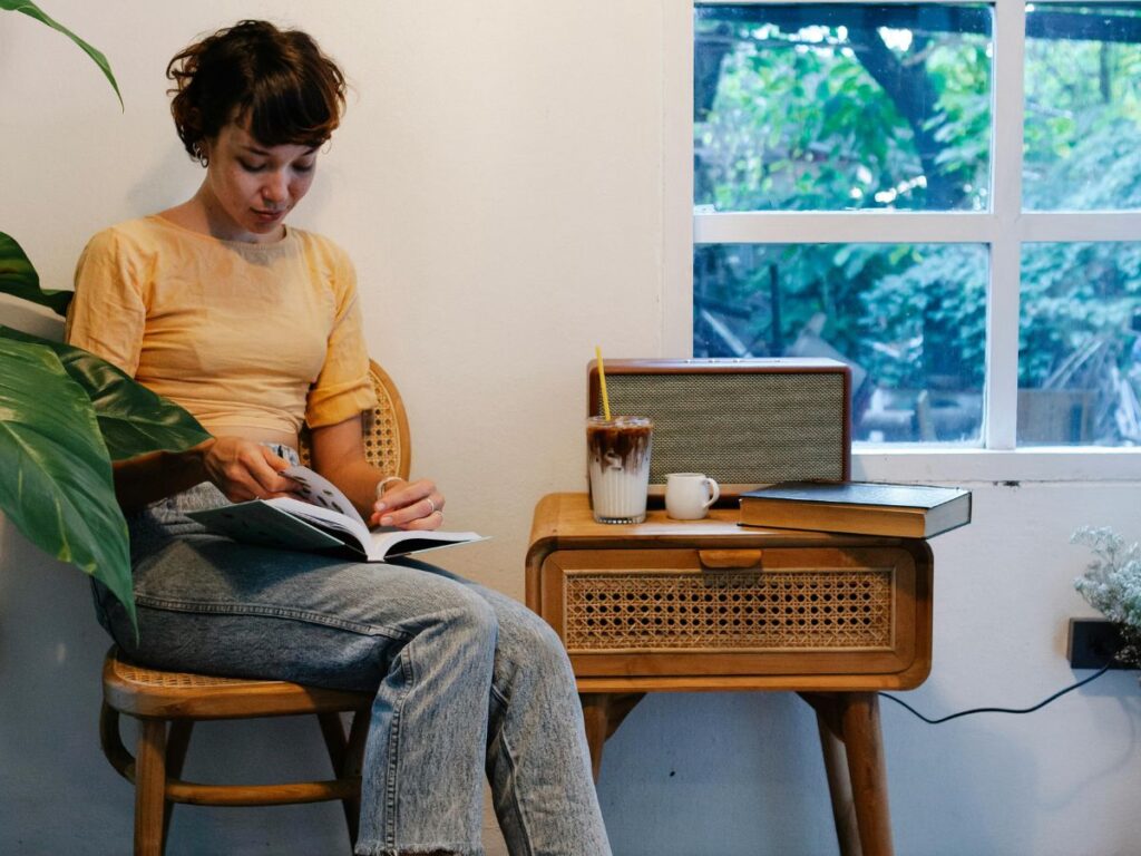 woman reading book in a cafe