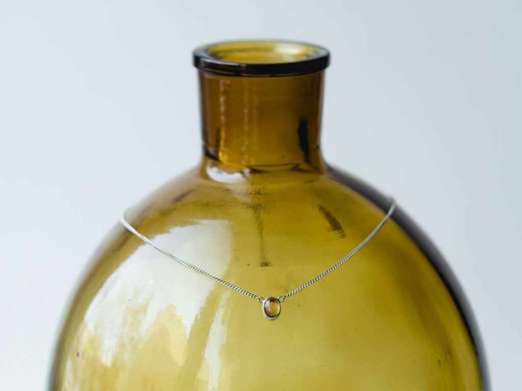 vintage necklace on bottle